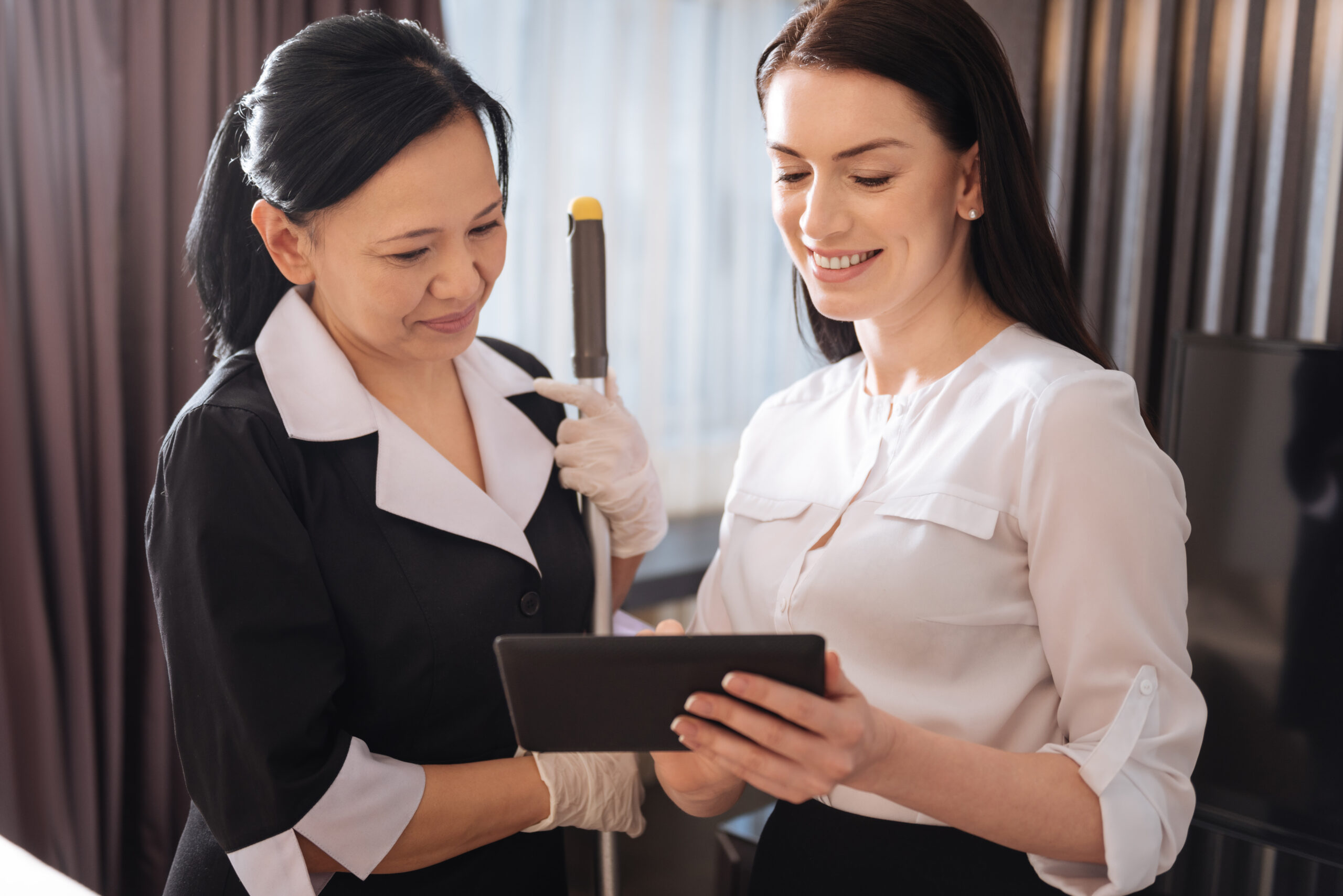 joyful pleasant women looking at the tablet screen